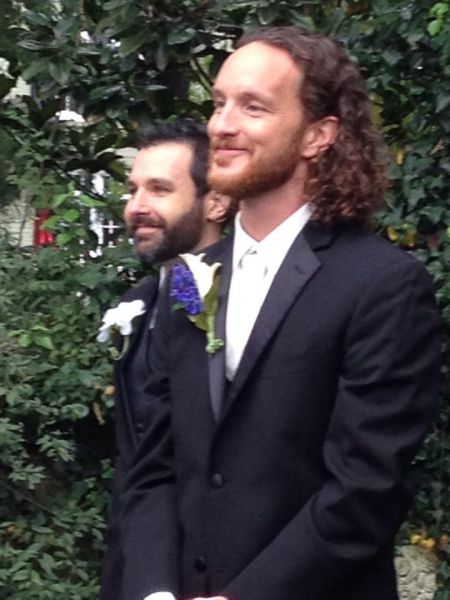 The groom glowing as the bride approaches the altar, with the officiant in the background.om. bringthgaryjpg.jpg